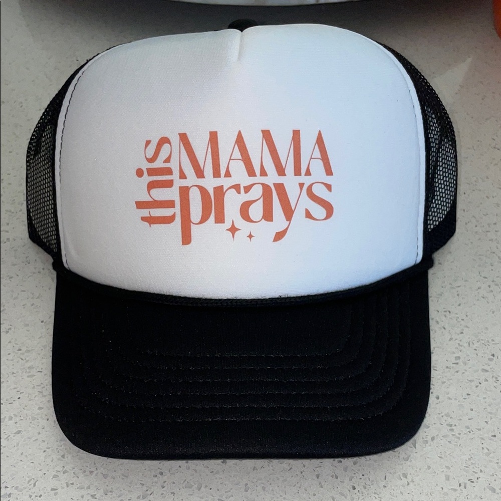 THIS MAMA PRAYS Black and White Trucker Hat with Orange Text